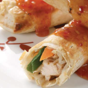 Three-chicken-and-vegetable-rolls-wrapped-in-Mountain-Bread-covered-in-sweet-chilli-sauce.