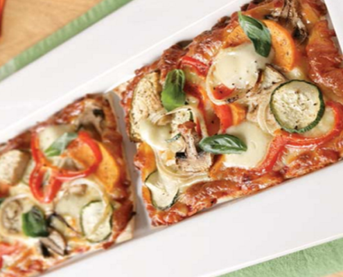 vegetarian-pizza-with-eggplant-zucchini-and-capsicum-topped-with-fresh-basil.