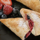 Raspberry-and-blueberry-triangles-with-creamed-cheese-dusted-with-sugar.