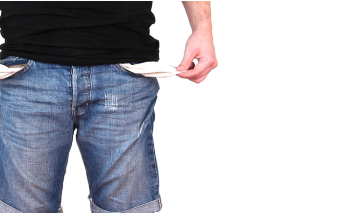 Coeliac on a shoestring budget man in jeans torso showing his empty pockets